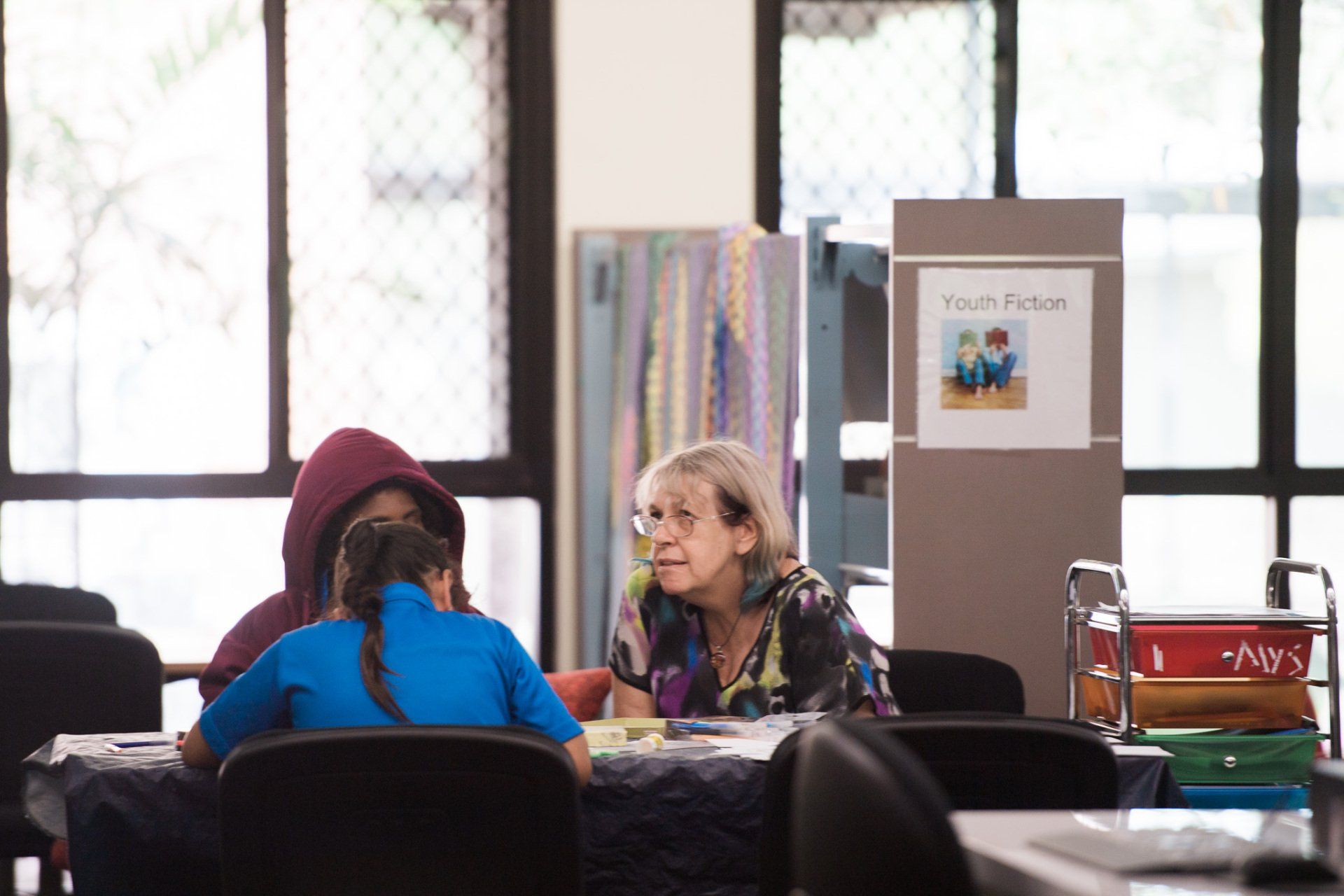 A group of people are sitting at a table in a room.