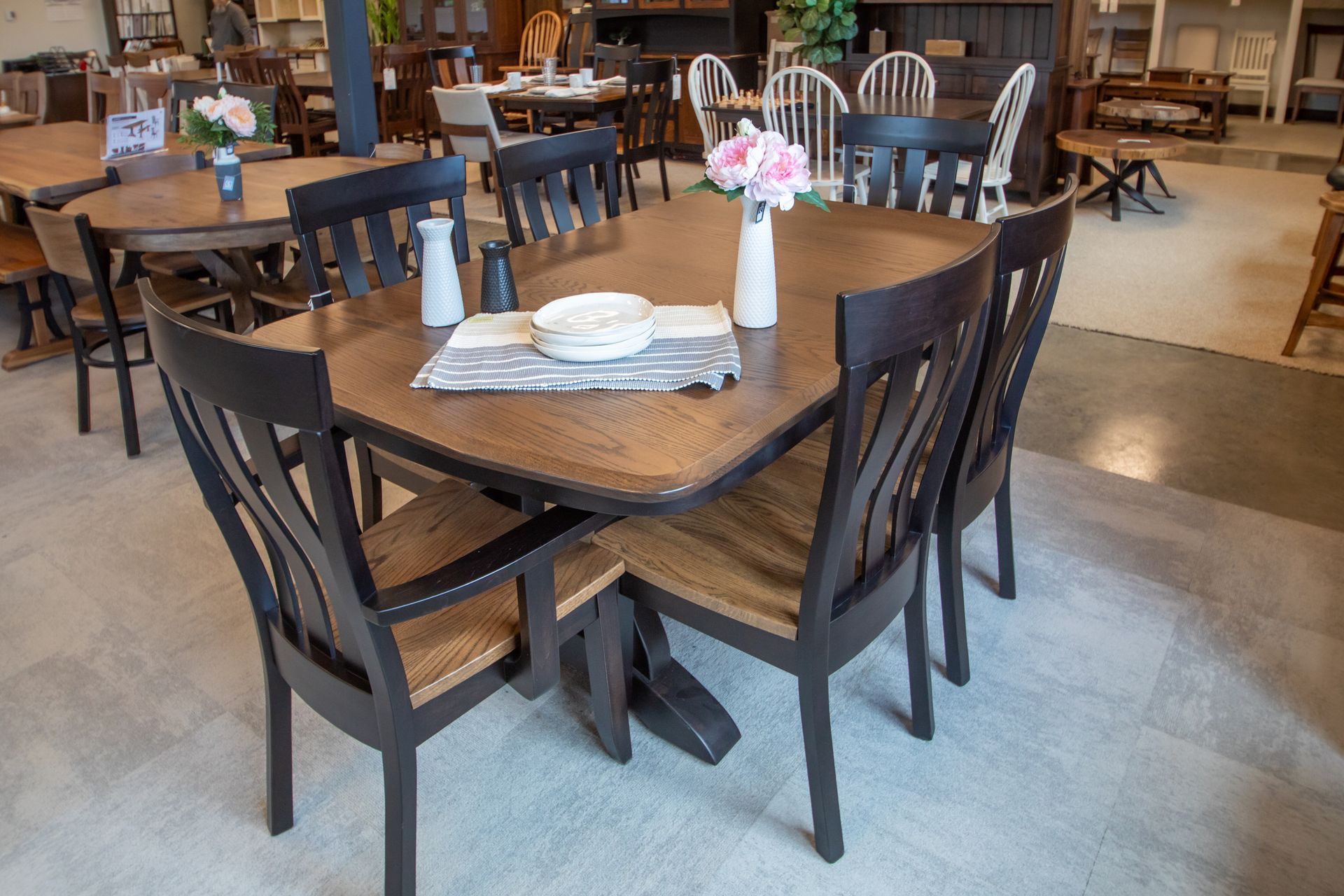 Dining table set with six chairs in a showroom.