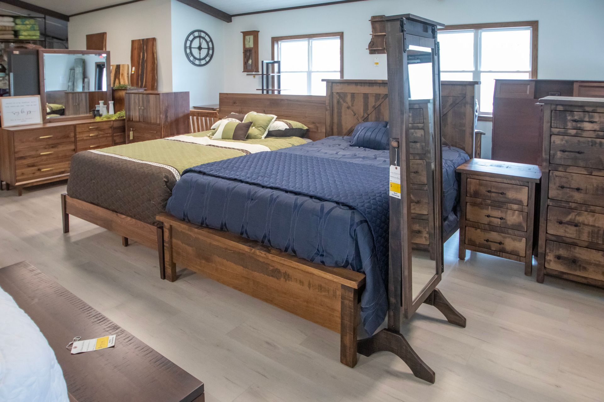 Bedroom furniture display with two beds and dressers.