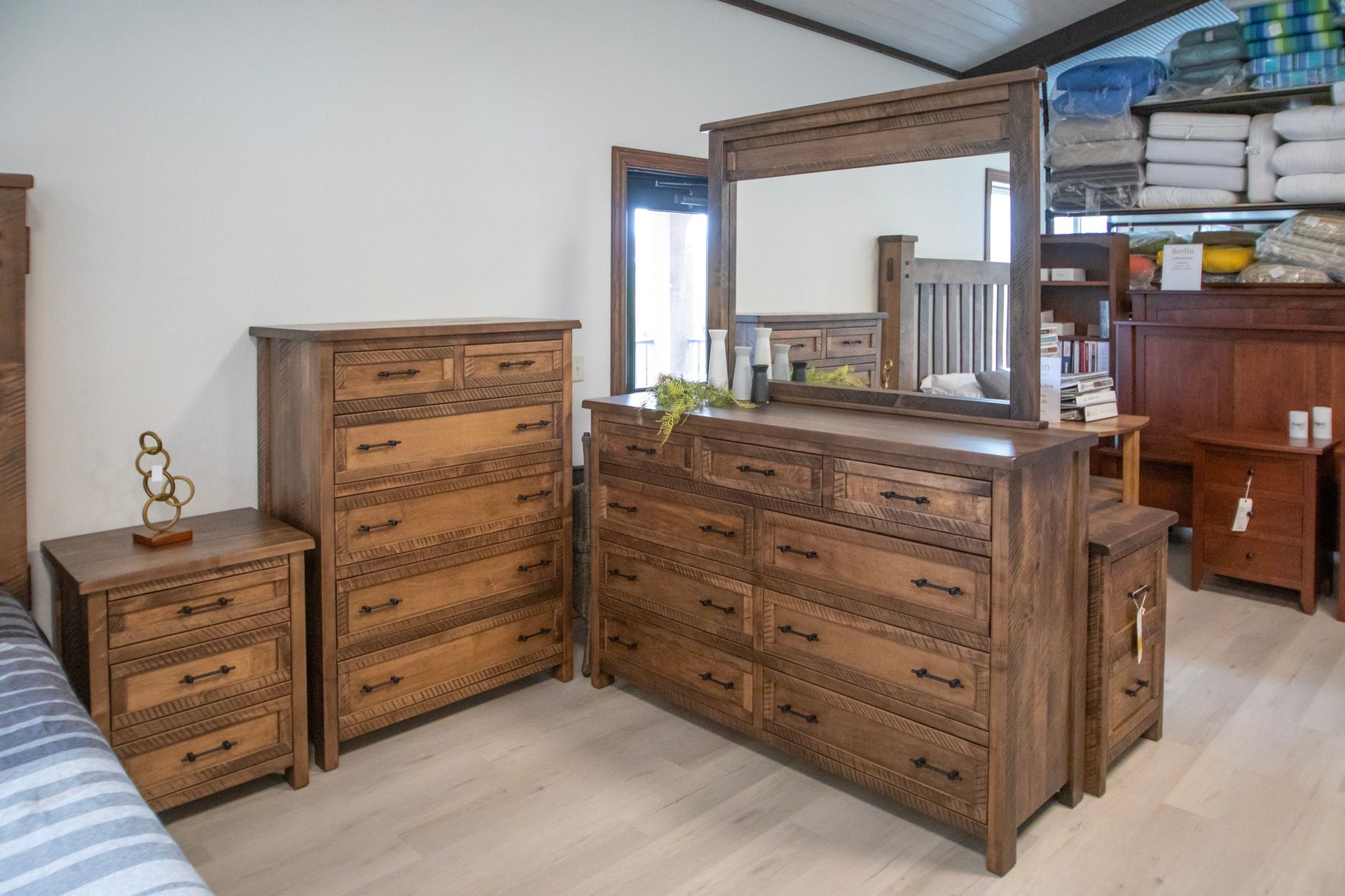 Bedroom furniture set in brown wood: dresser, chest of drawers, nightstand, and mirror.