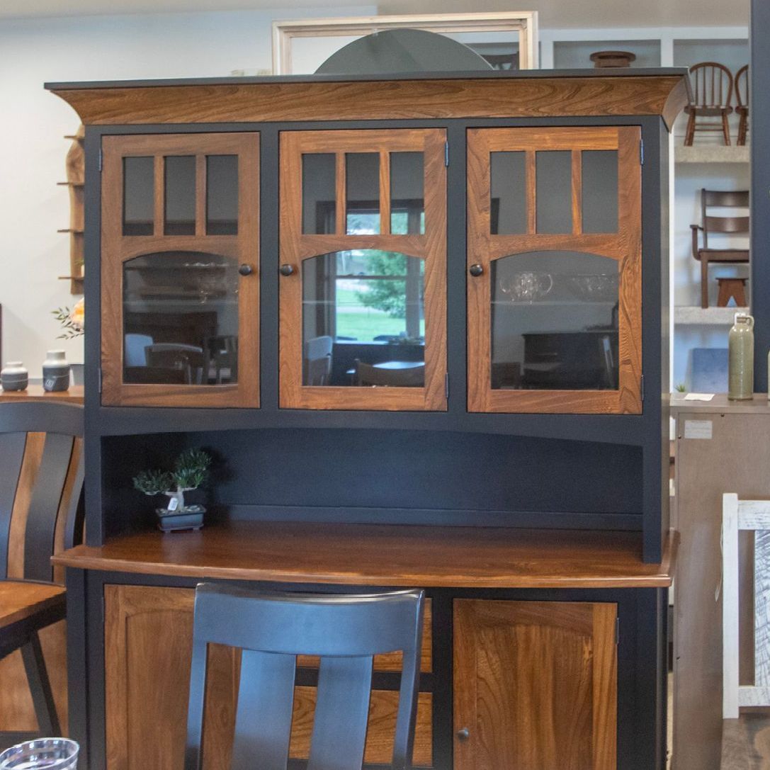 Wooden hutch with glass-fronted cabinets and a desk area, featuring a bonsai tree, brown and black finish.