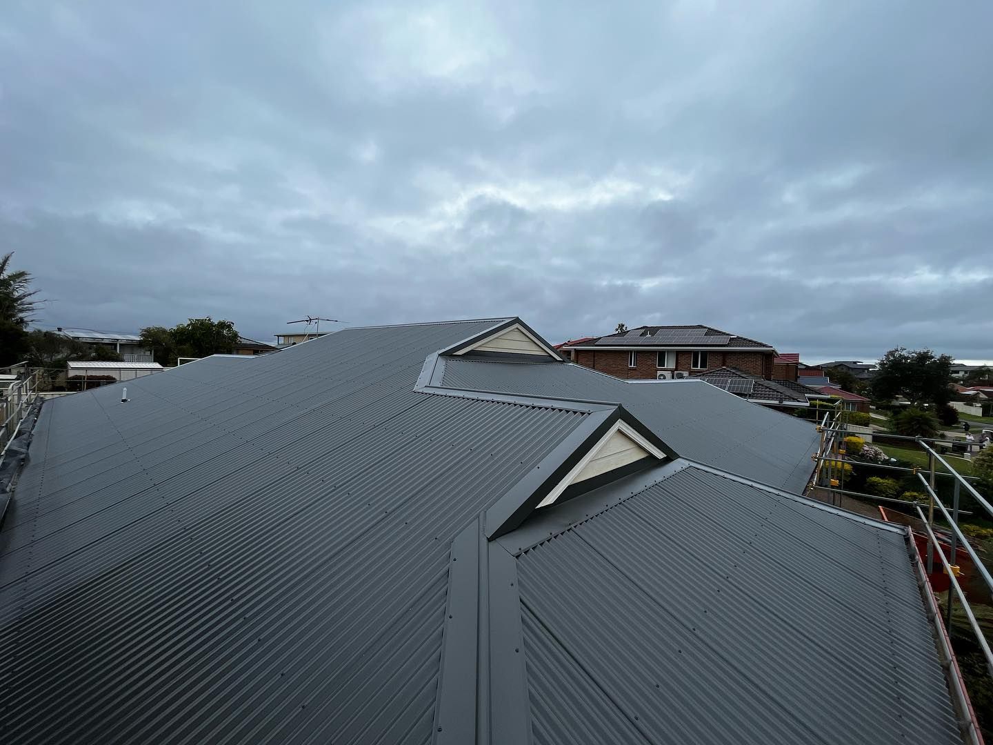 Grey Roof In Cloudy Weather — Roofer in Newcastle, NSW
