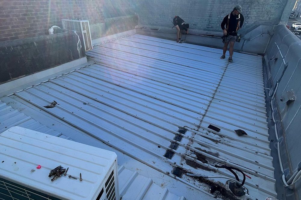 Two Man Doing A Maintenance Checkup Of The Roof — Roofer in Hunter Valley, NSW