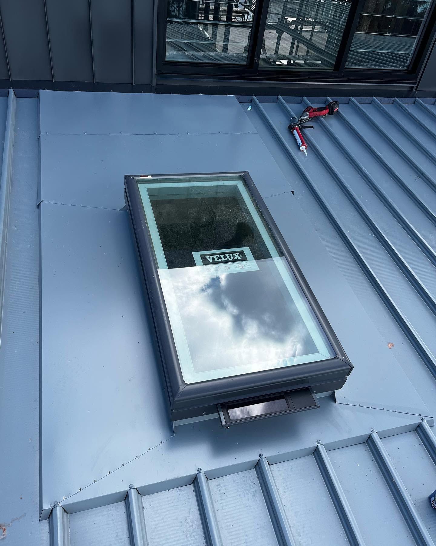 Roof Skylight With Glass Reflecting Clouds — Lanewoods Roofing in Lake Macquarie, NSW