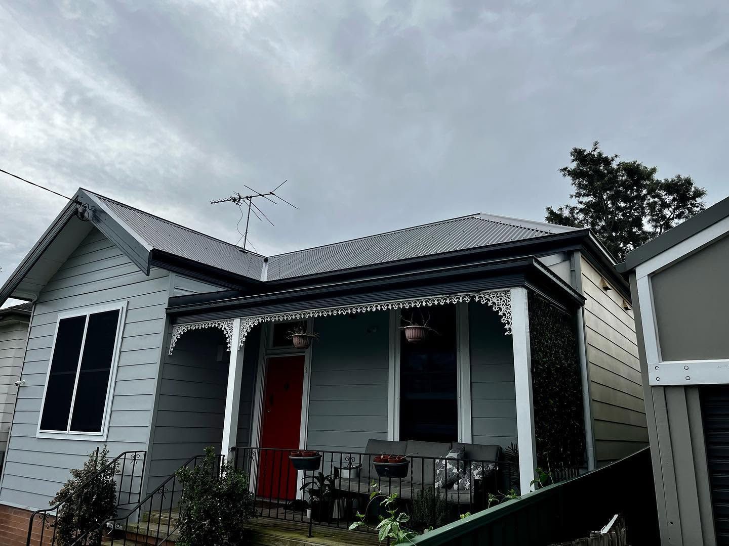 Gray House With a Red Front Door — Lanewoods Roofing in Hunter Valley, NSW