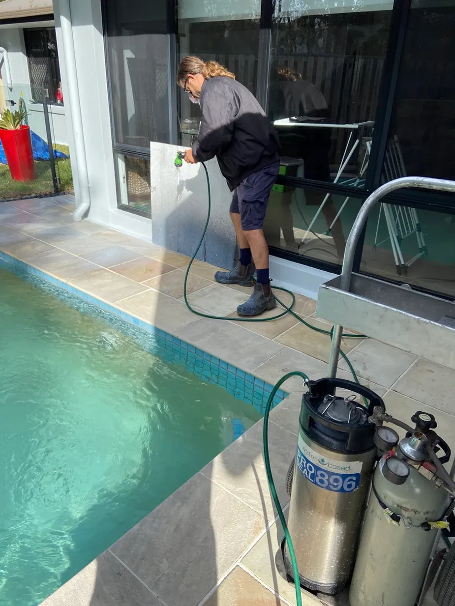 concrete sealing around a pool in action