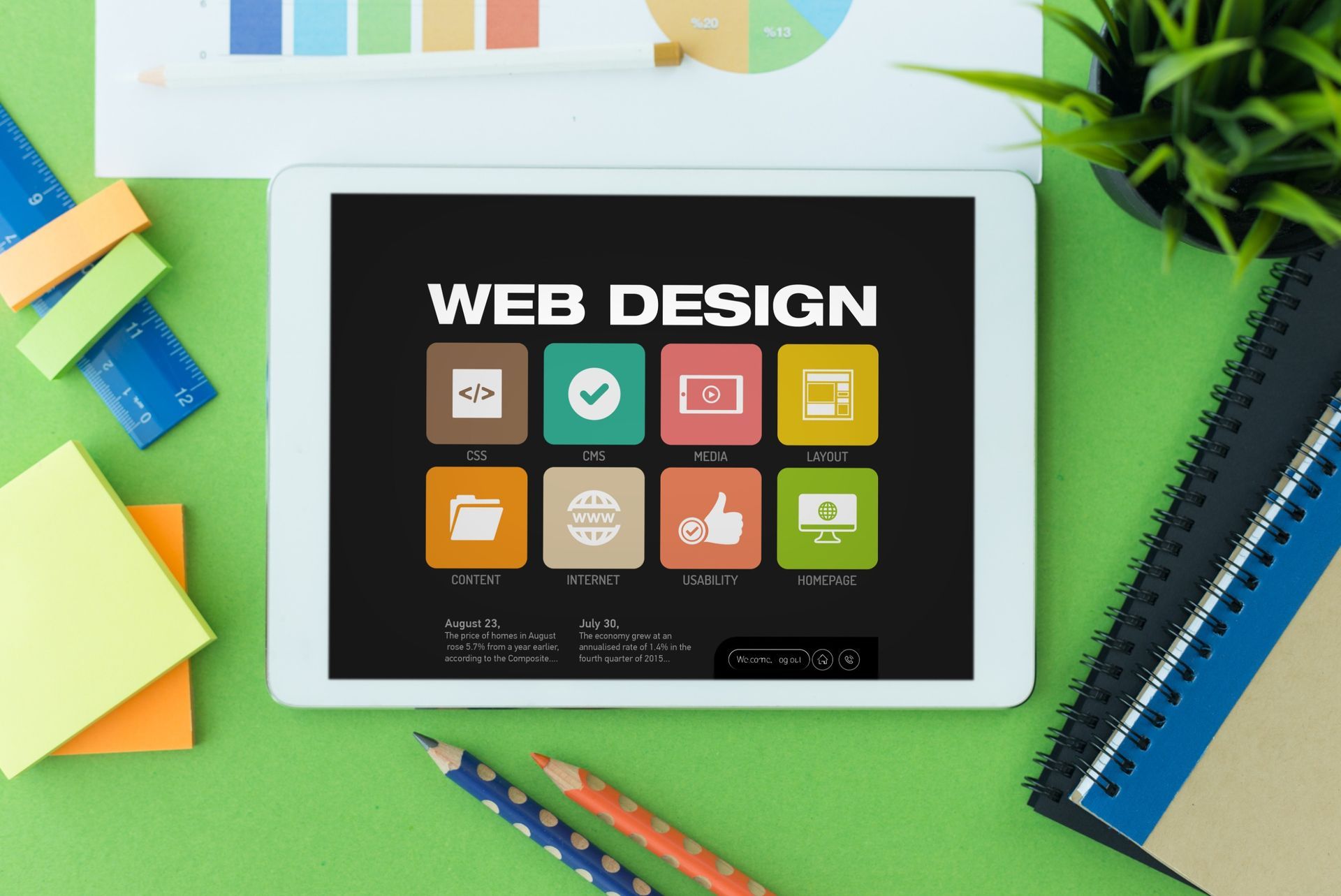 A tablet with the word web design on it is sitting on a desk.