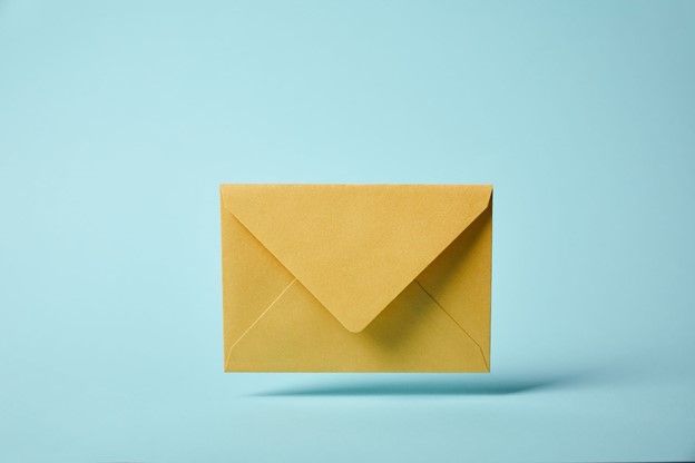A yellow envelope is floating in the air on a blue background.