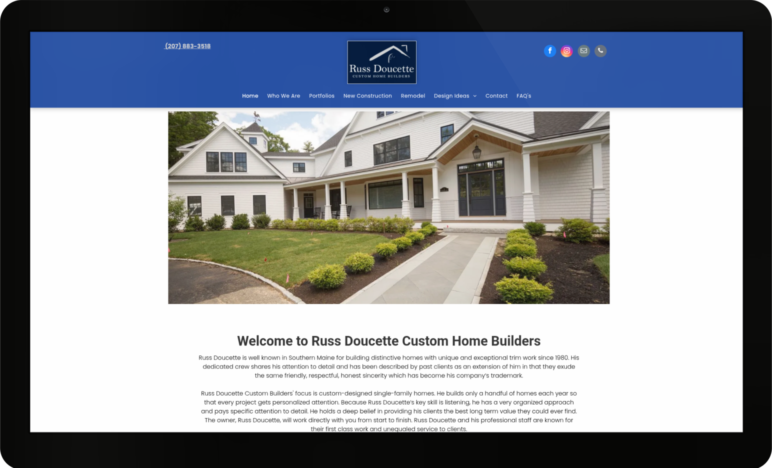 A computer screen shows a large house and the website huss doucette