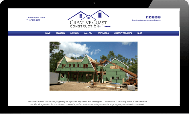 A computer screen shows the website for creative coast construction