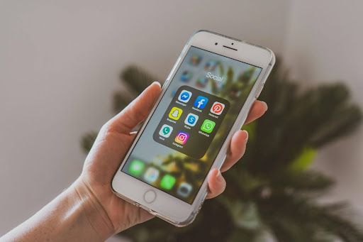 A person is holding a cell phone in their hand.
