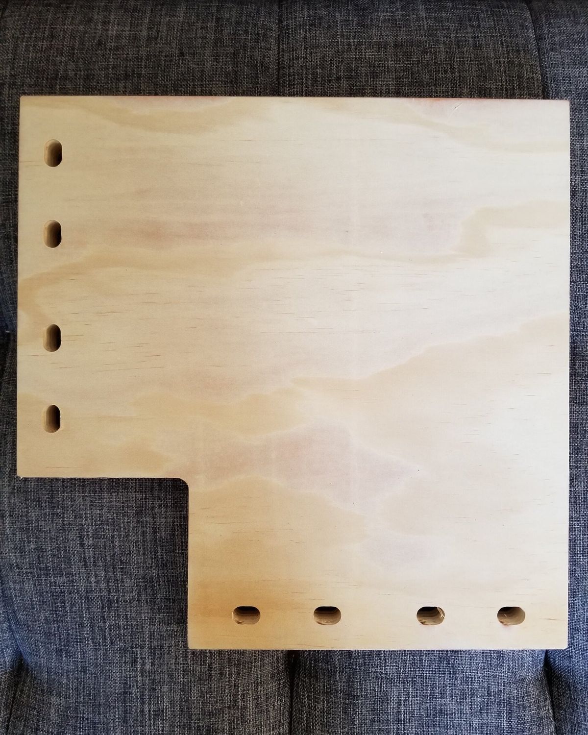 Underside view of wraparound corner cat shelf showing white mounting brackets and adjustable hinges for corner installation.