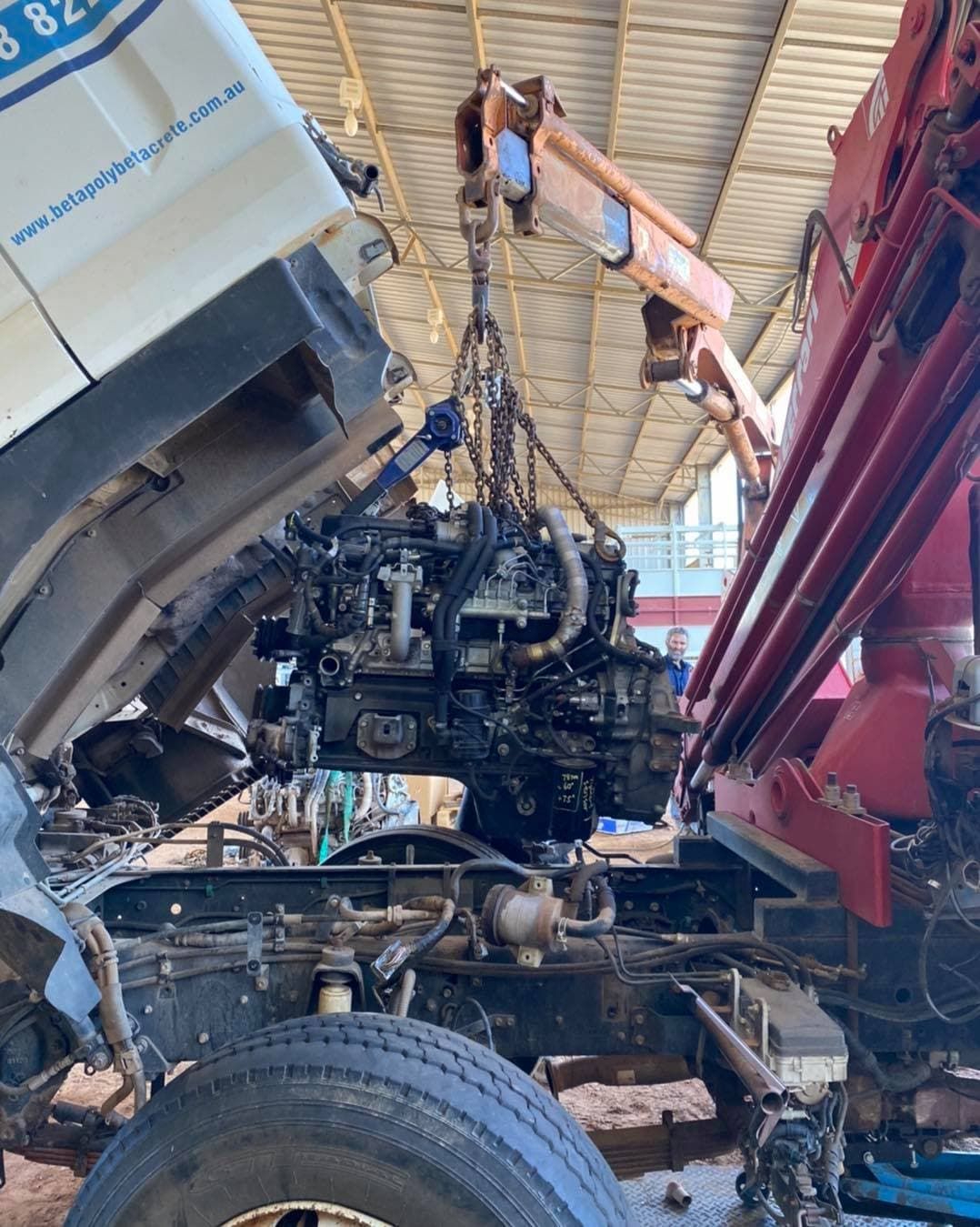 A Truck Engine Being Lifted Out by a Crane, in a Repair Setting — Traction Diesel Services in Clermont, QLD