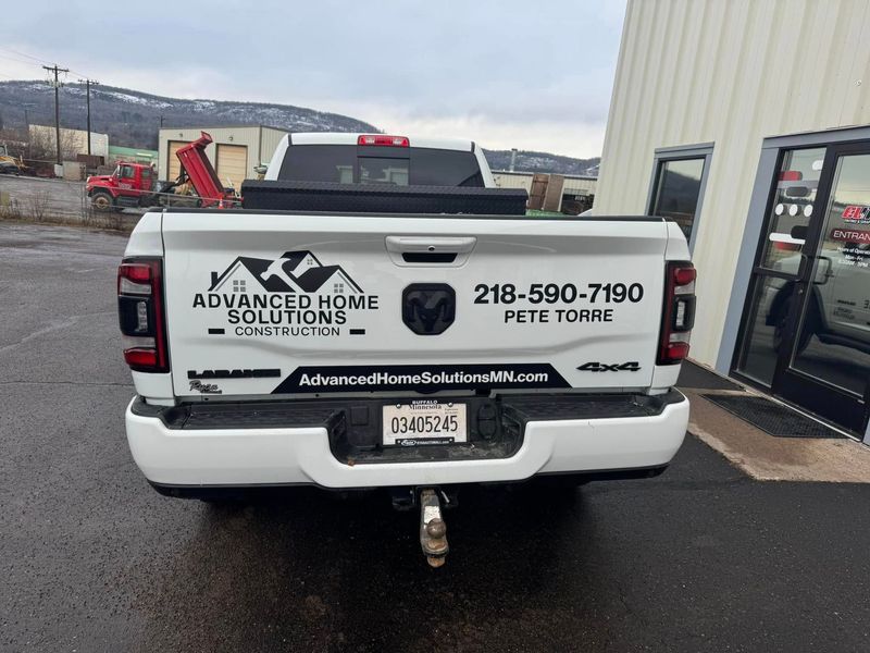White utility truck with Aqua Joe's logo and phone number parked beside a building in a lot