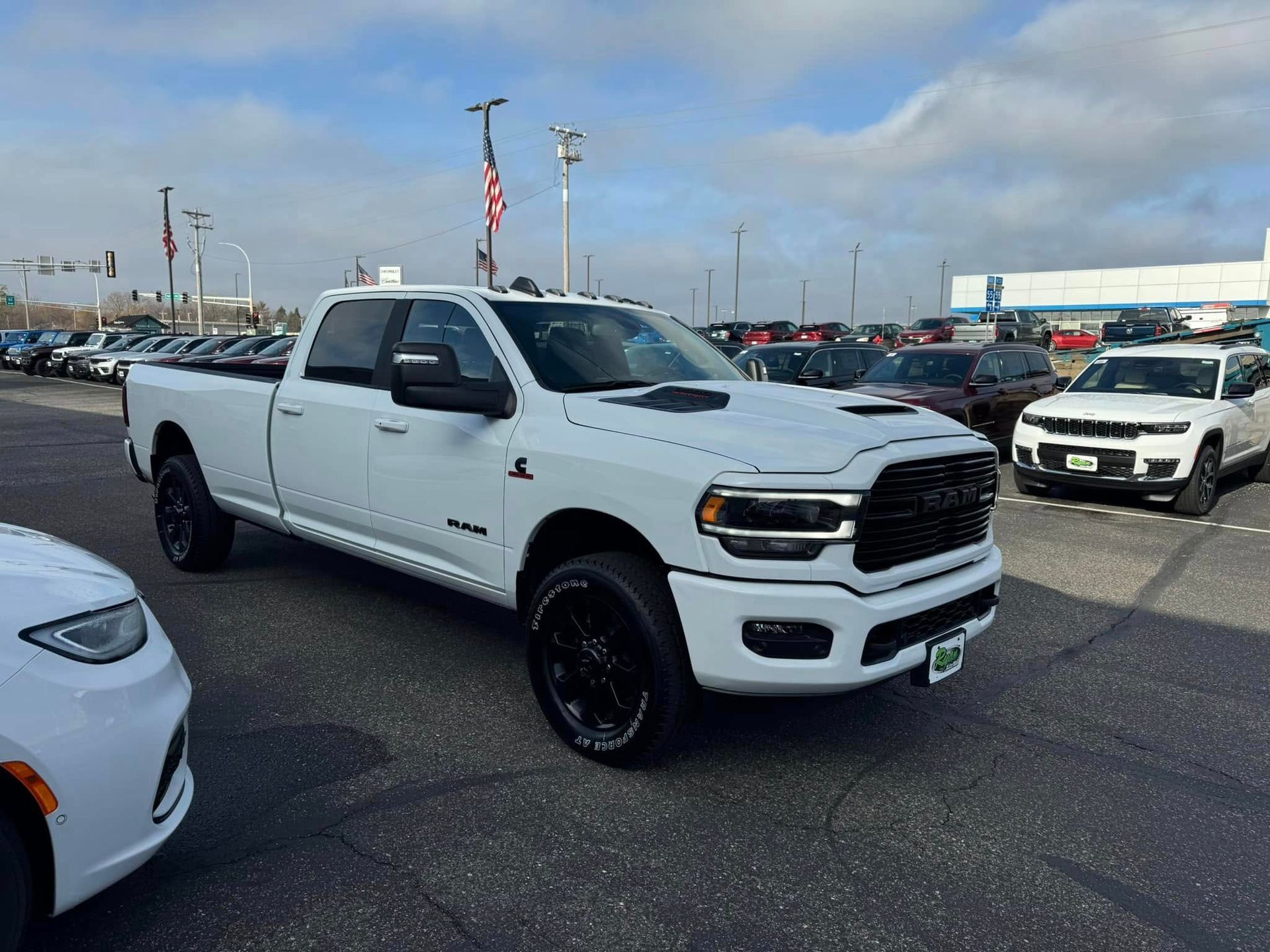 White pickup truck parked in a car lot under a clear sky