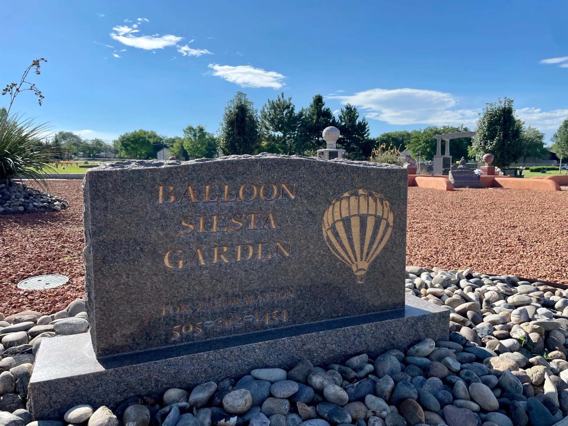Grave marker with hot air balloon graphic at the Balloon Siesta Garden in a cemetery.
