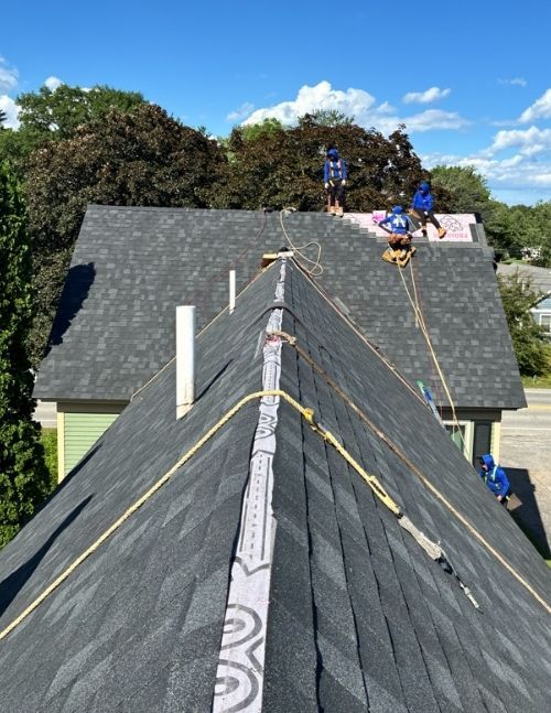 blue skies over roof replacement project in Maine