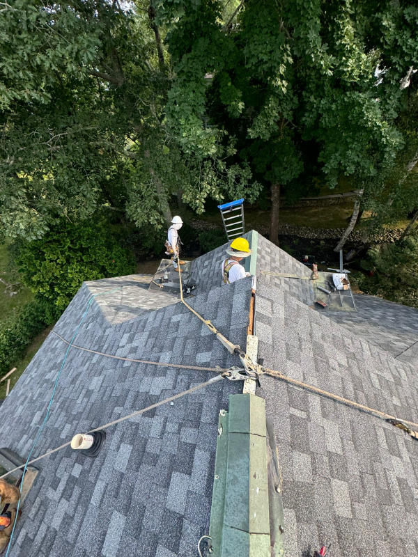 aerial shot of workers installing new roof in Maine