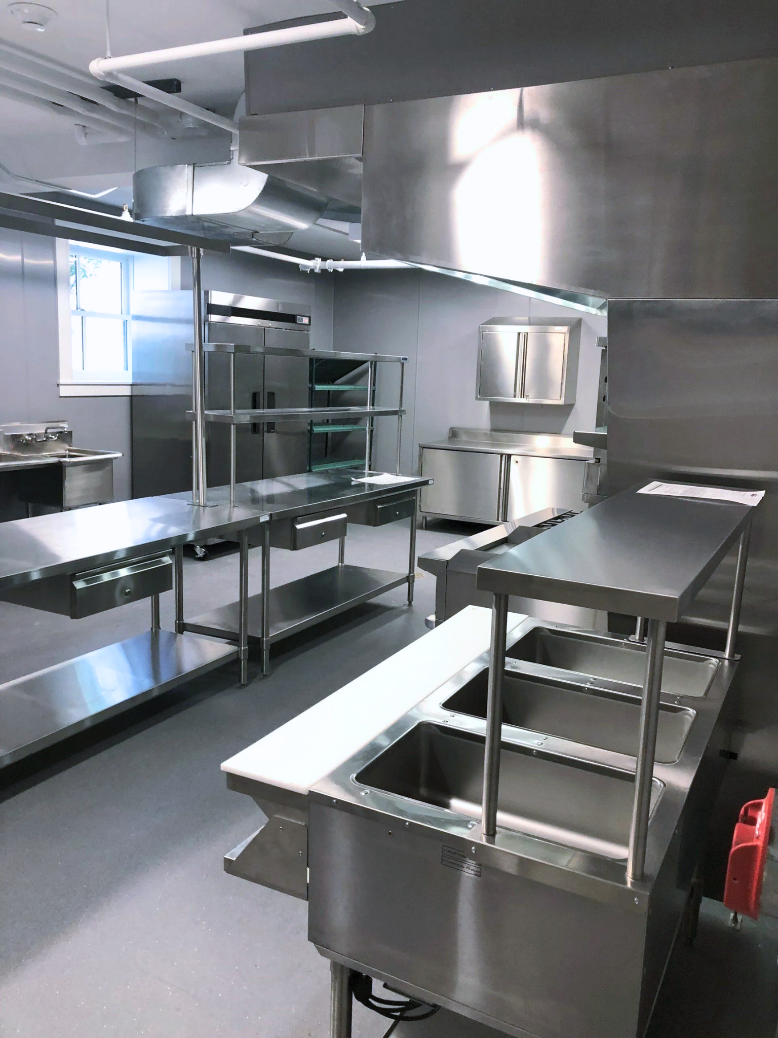 a kitchen with stainless steel appliances and a fire extinguisher