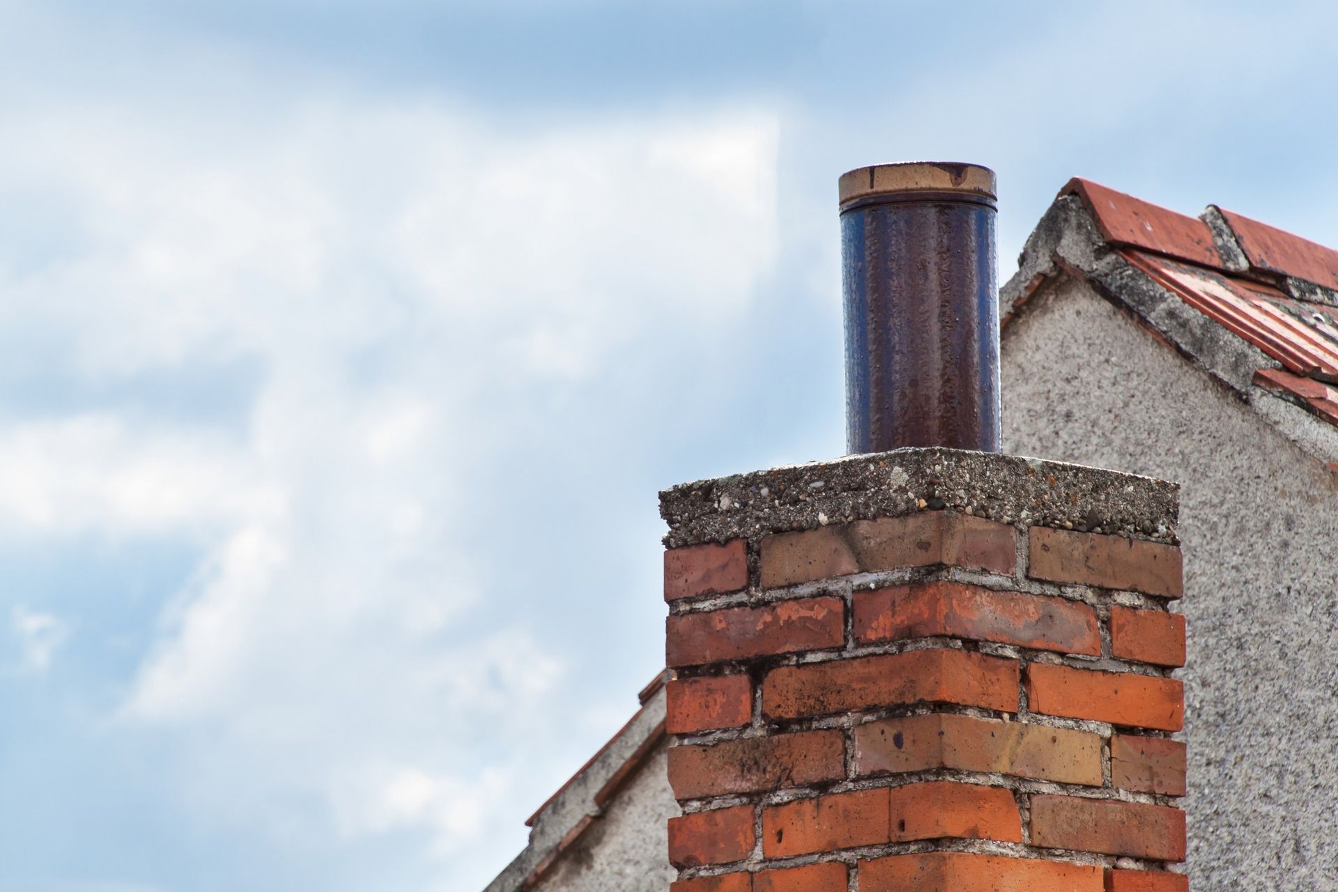 A brick chimney is sitting on top of a building.