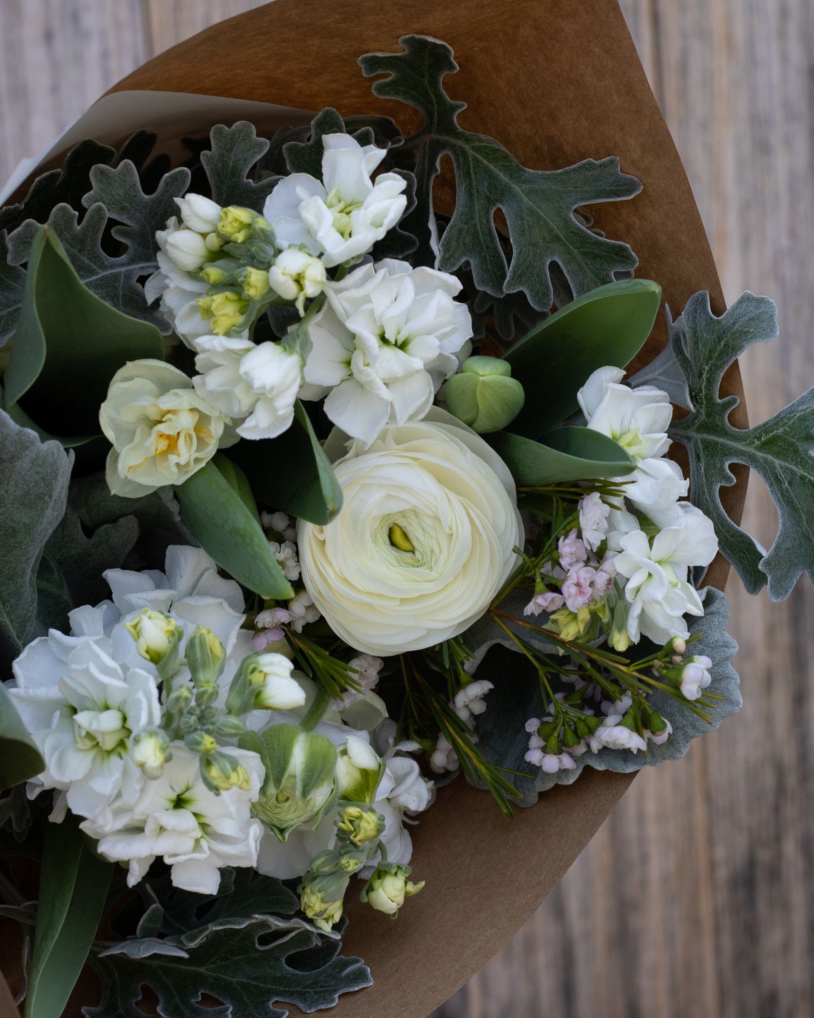 All white bouquet with US grown stock, dusty miller, and ranunculus
