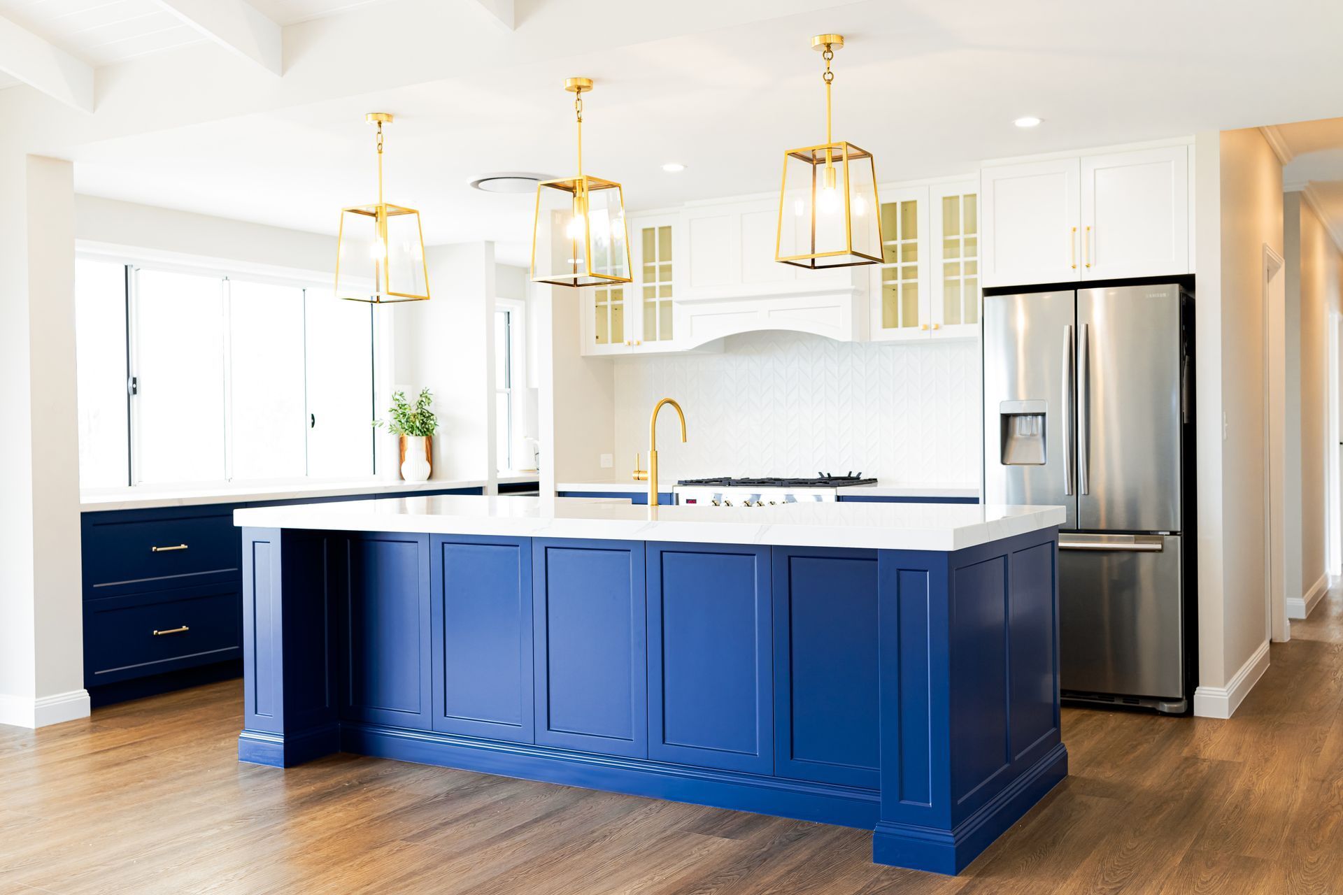 A Kitchen With Blue Cabinets, White Cabinets, Stainless Steel Appliances and a Large Island — Truline Cabinets In Cooroy, QLD