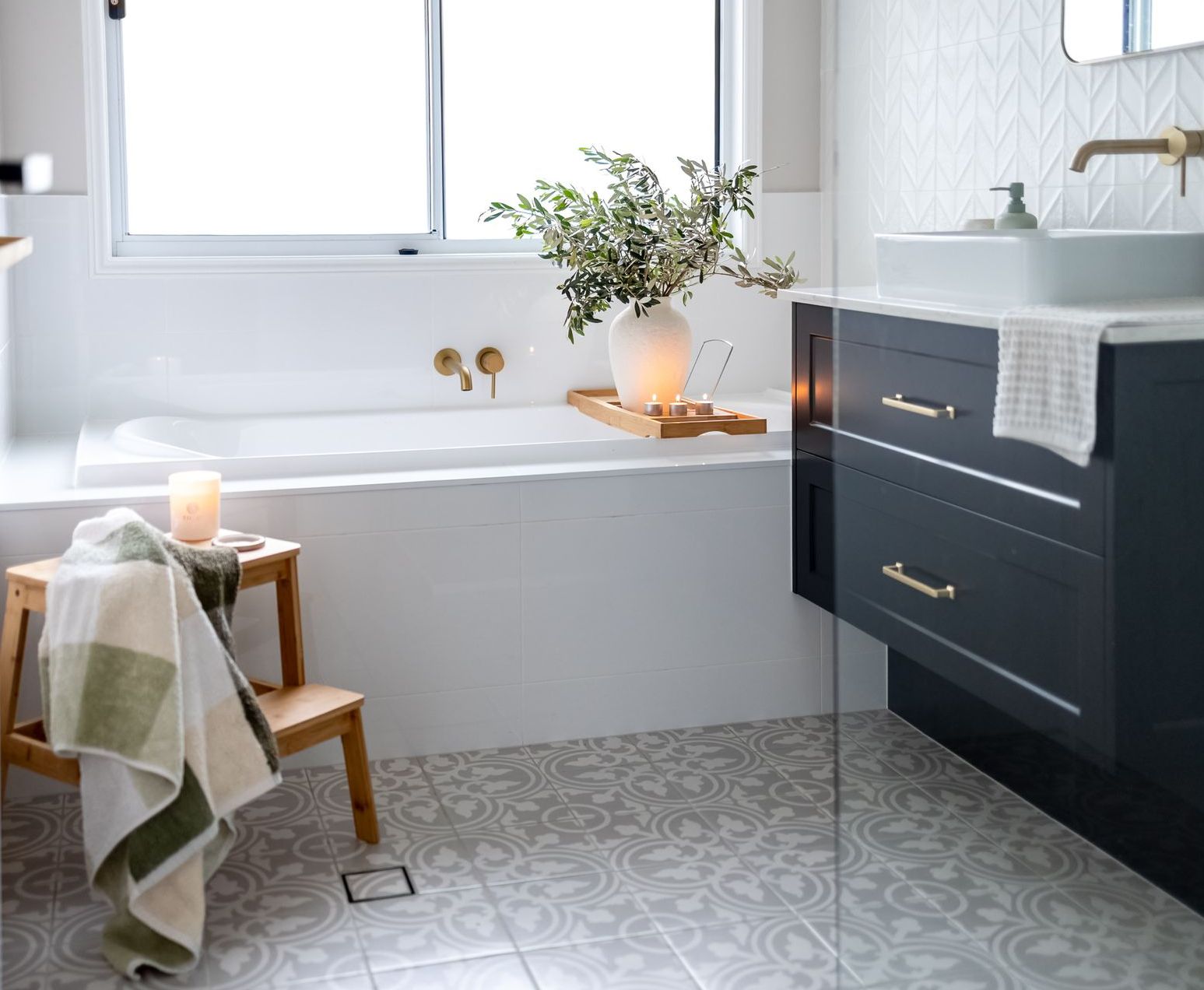A Bathroom With A Bath Tub and Stool — Truline Cabinets In Tuchekoi, QLD