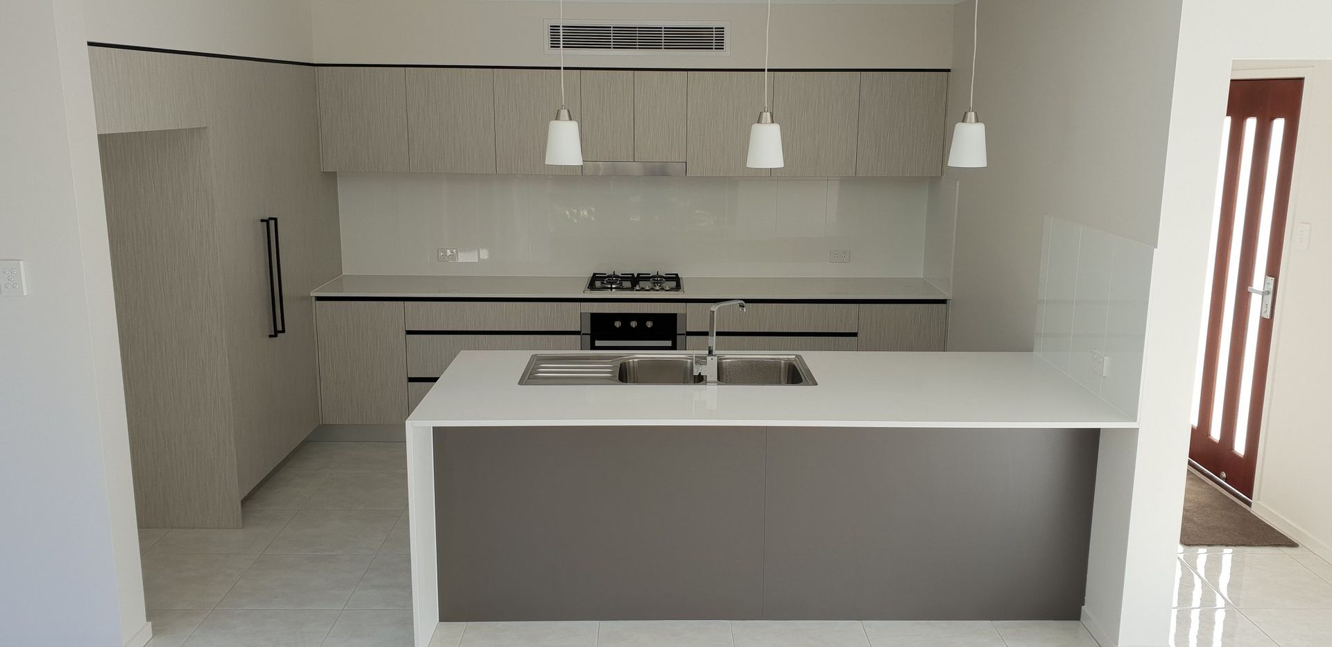 A Kitchen With a Stove, Sink, and Cabinets — Truline Cabinets In Cooroy, QLD