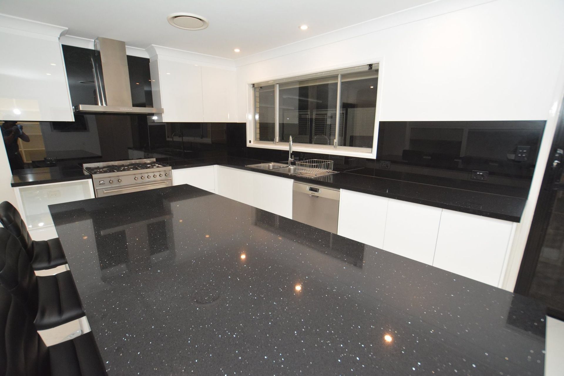 A Kitchen With Black Counter Tops and White Cabinets — Truline Cabinets In Buderim, QLD