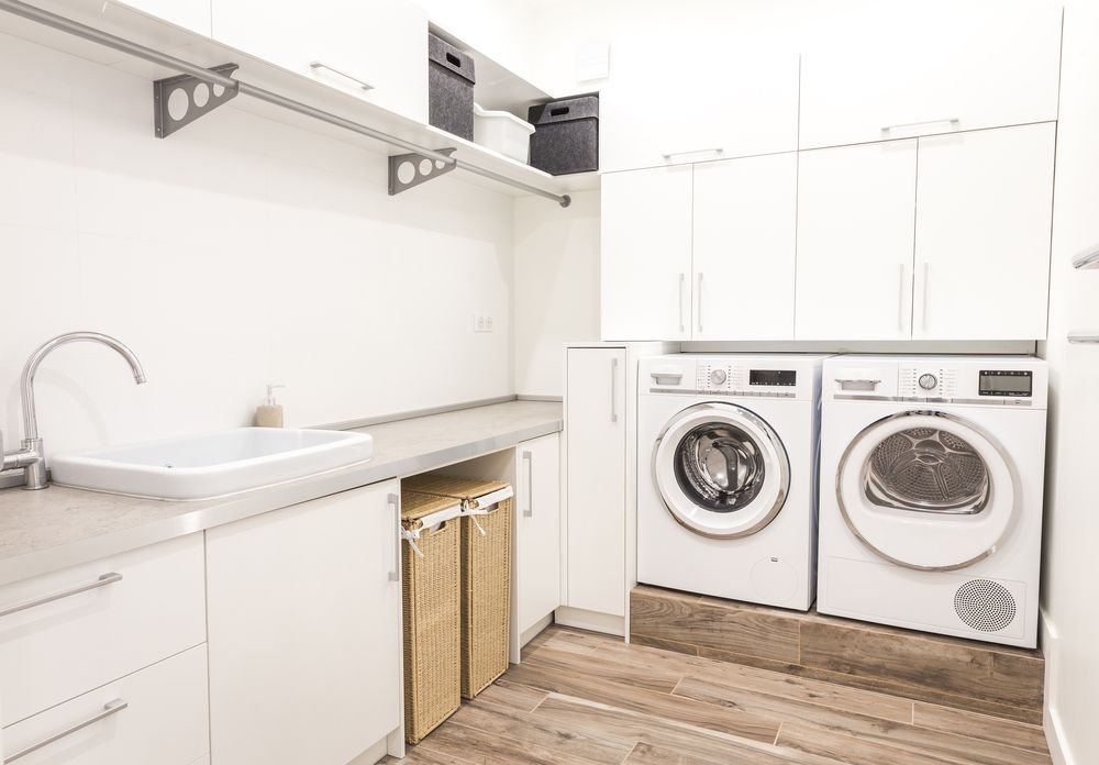 A White Washer and Dryer Surrounded by White Cabinets — Truline Cabinets In Nambour, QLD