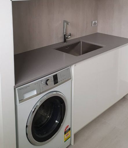 A Laundry Room With a Washer and Dryer and a Sink — Truline Cabinets In Tuchekoi, QLD