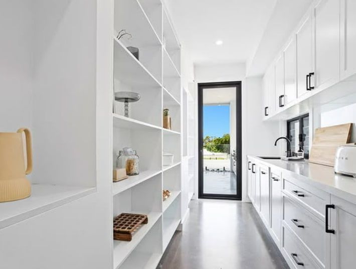 A Kitchen With White Cabinets and Shelves and a Large Window — Truline Cabinets In Buderim, QLD