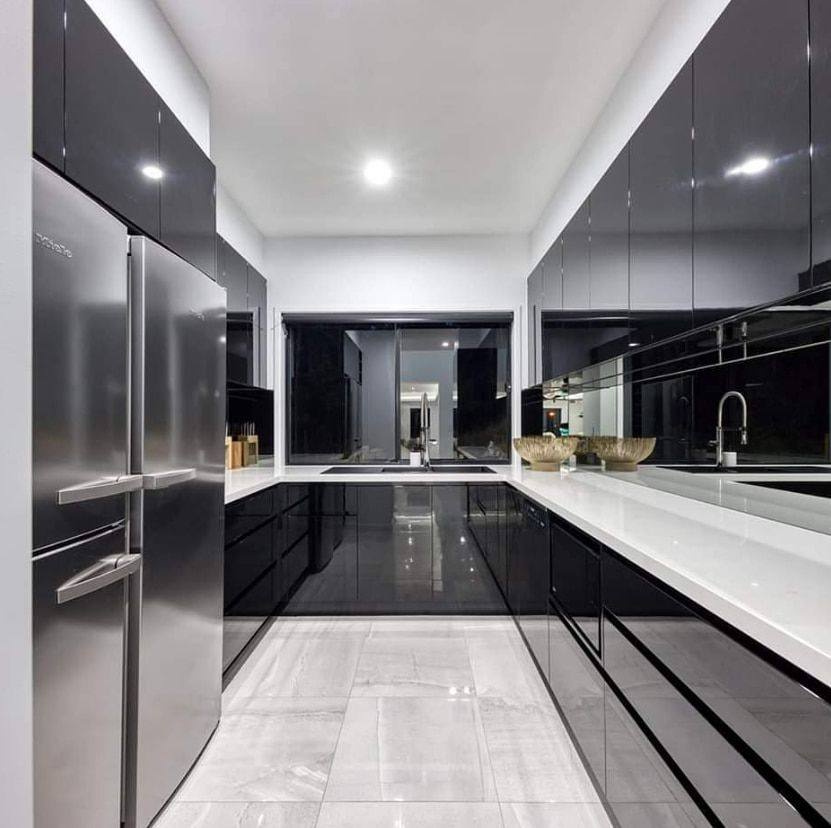 A Kitchen With Black Cabinets and Stainless Steel Appliances — Truline Cabinets In Buderim, QLD