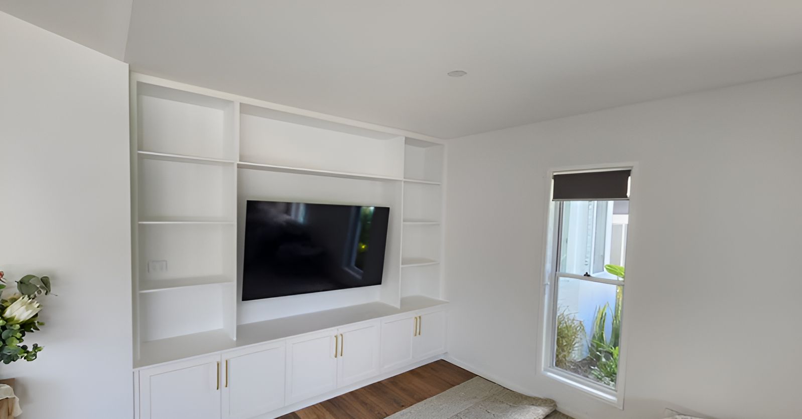 A Living Room With a Large Flat Screen Tv Mounted on the Wall — Truline Cabinets In Buderim, QLD