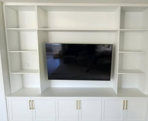 A White Entertainment Center With a Flat Screen Tv Mounted to the Wall — Truline Cabinets In Tuchekoi, QLD