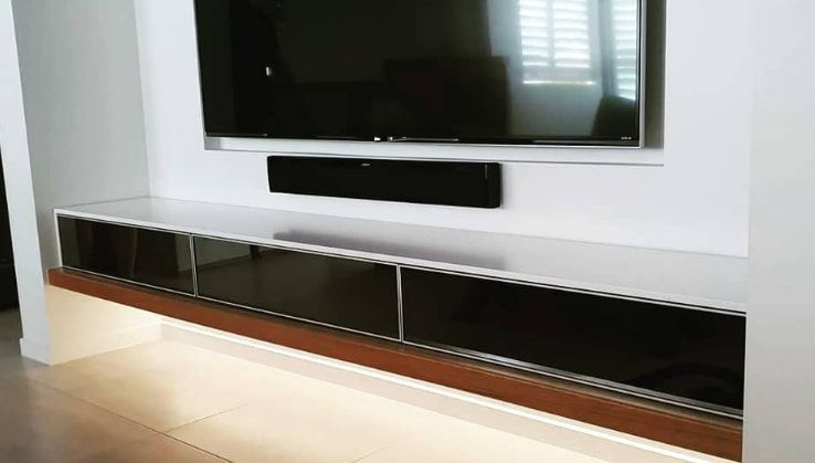 A Living Room With a Flat Screen Tv Mounted to the Wall — Truline Cabinets In Nambour, QLD