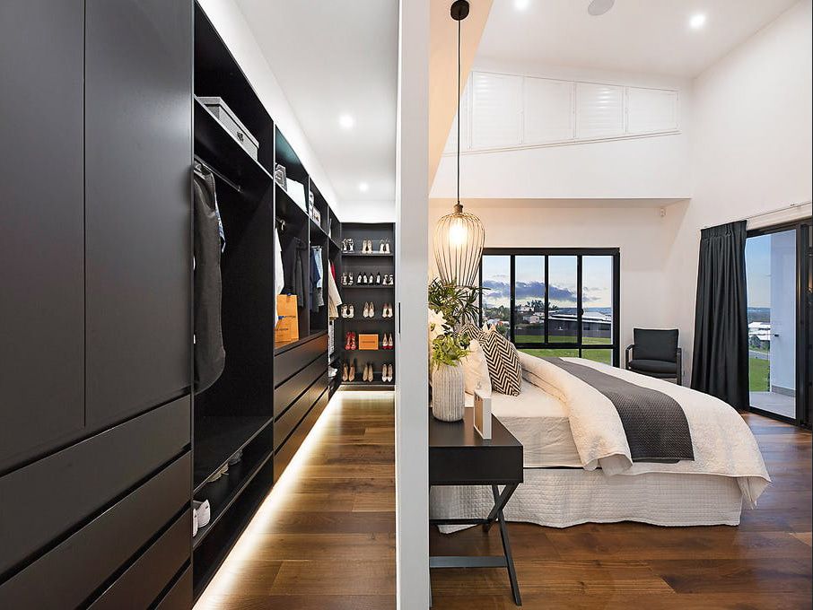 Bedroom with White Bed and Black Wardrobe — Truline Cabinets In Tuchekoi, QLD