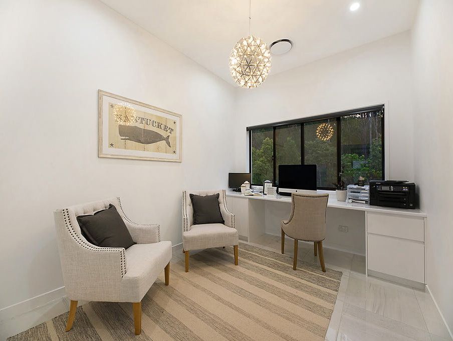 Two Chairs Are Sitting at a Desk in an Office Cubicle — Truline Cabinets In Tuchekoi, QLD