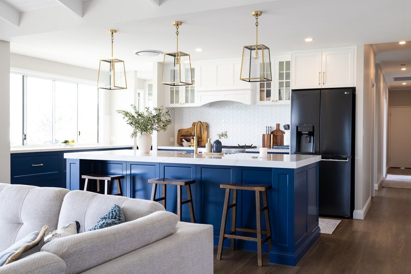 Blue and White Kitchen With an Island, Gold Pendant Lights, and a Black Refrigerator — Truline Cabinets In Tuchekoi, QLD