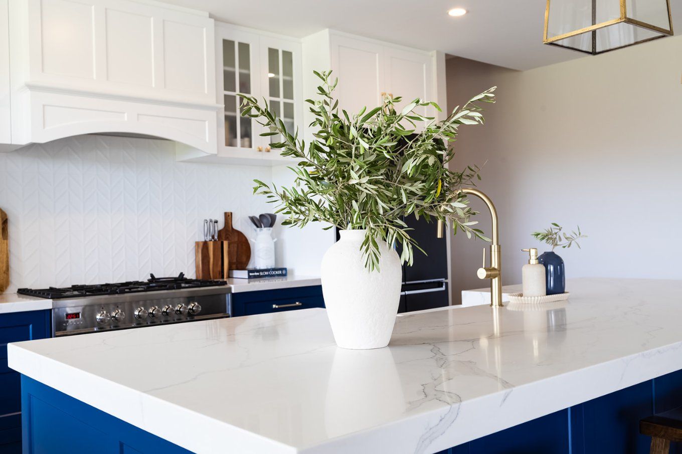 A Modern Kitchen Featuring a White Countertop and Blue Cabinets — Truline Cabinets In Tuchekoi, QLD