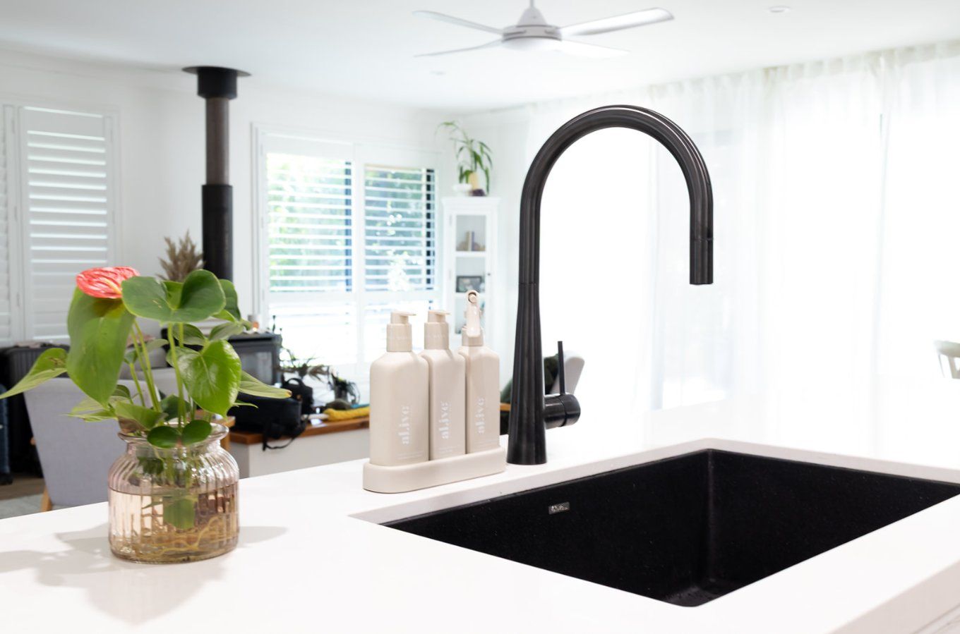 A Modern Kitchen Sink With a Black Faucet and Sink — Truline Cabinets In Tuchekoi, QLD