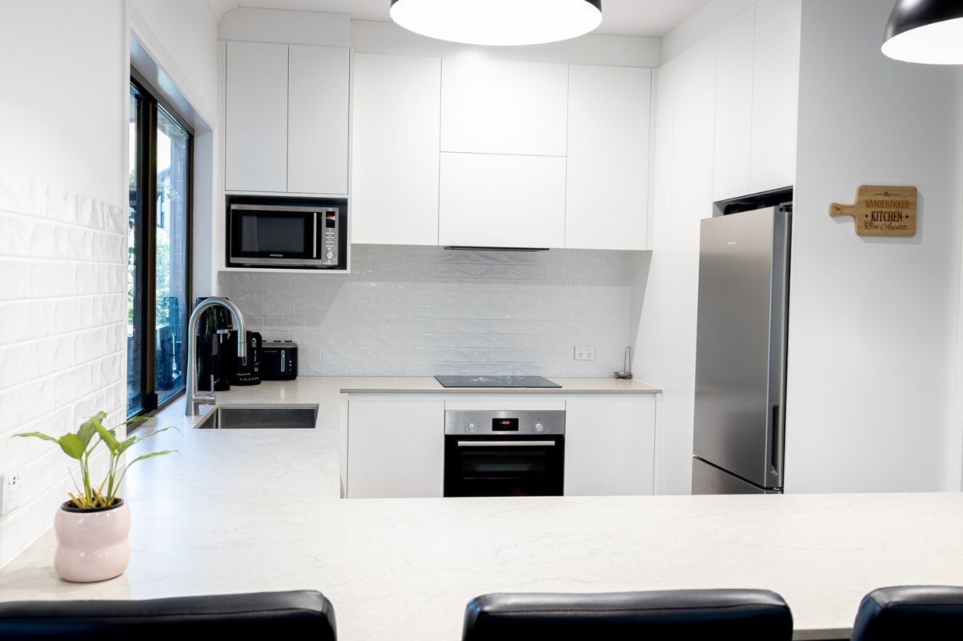 Modern White Kitchen With Stainless Steel Refrigerator, Oven, and Microwave — Truline Cabinets In Tuchekoi, QLD