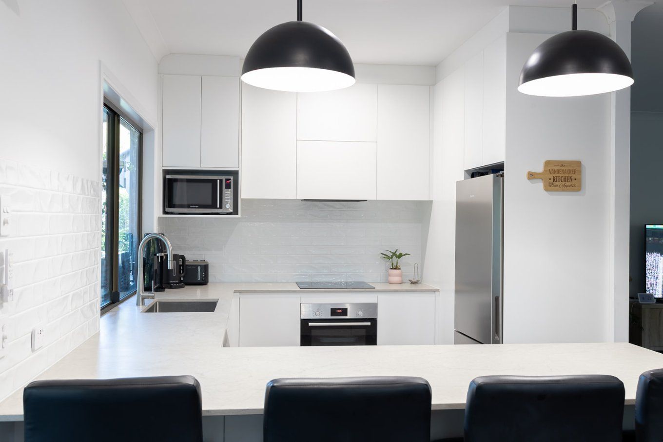 Modern White Kitchen With a Stainless Steel Refrigerator and a Large White Countertop — Truline Cabinets In Tuchekoi, QLD
