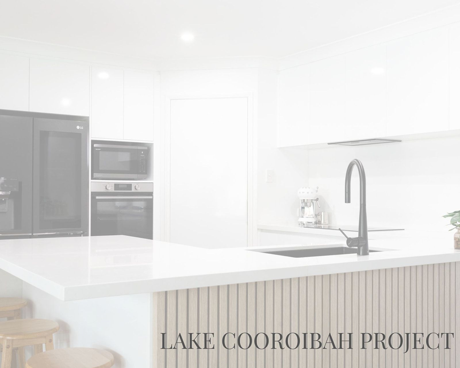 Modern White Kitchen With Black Appliances and a Light-colored Countertop — Truline Cabinets In Tuchekoi, QLD