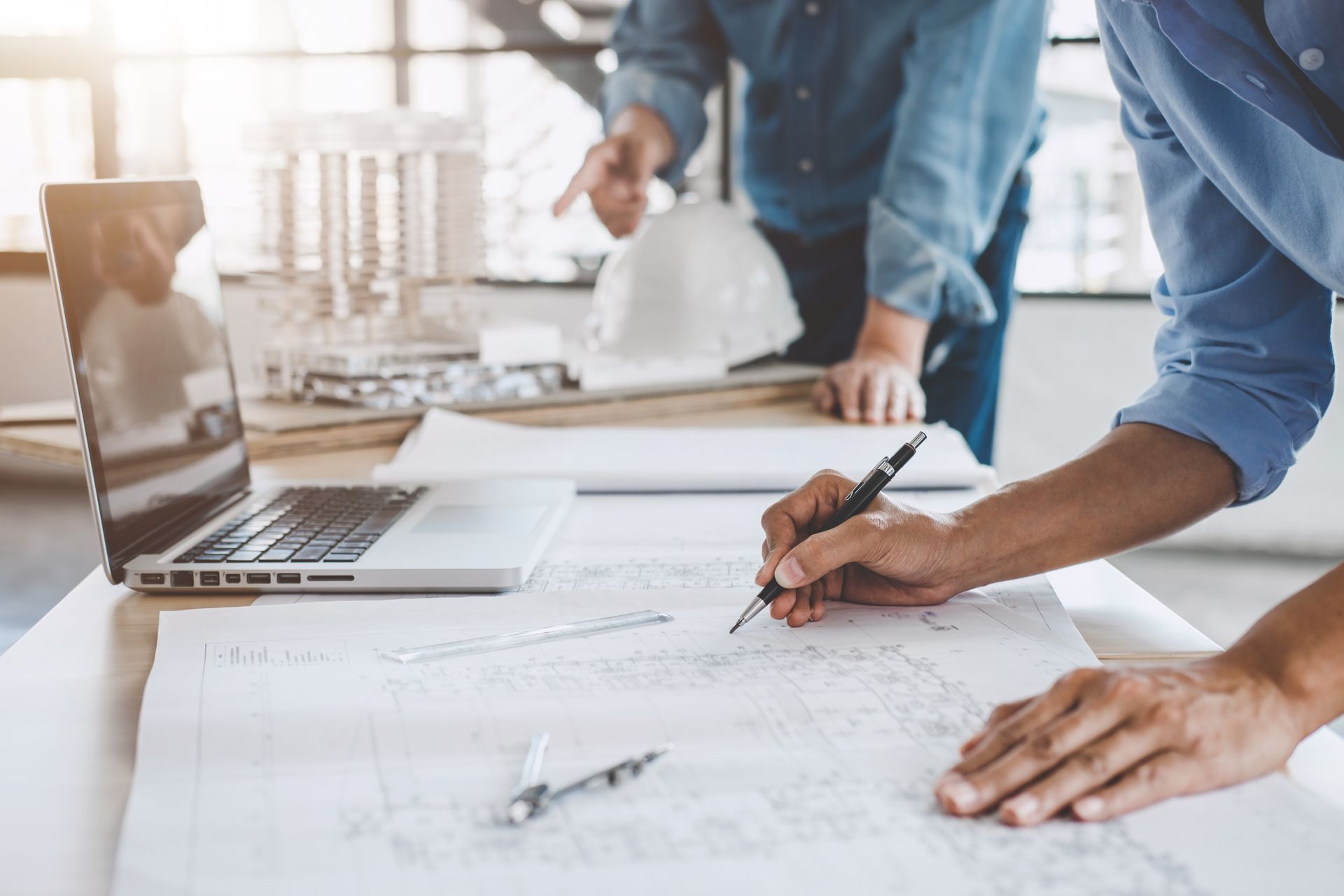 InInfrastructure engineer works on network design and documentation using CAD and paper drawings