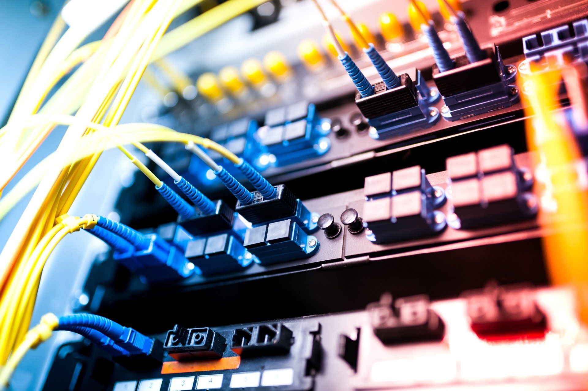 Fiber optic cables connected to a server in a data center.