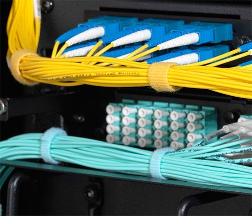 A bunch of wires are connected to each other in a rack