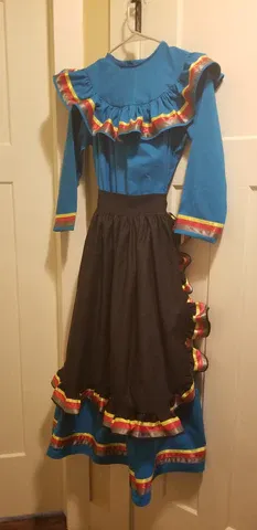 A blue dress and black skirt are hanging on a hanger.