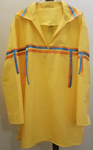 A yellow shirt with blue and orange stripes is hanging on a hanger.