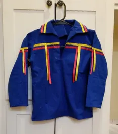 A blue shirt with red and yellow stripes is hanging on a hanger